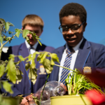 Two participants working in community garden