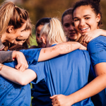 Group of young women in a group huddle